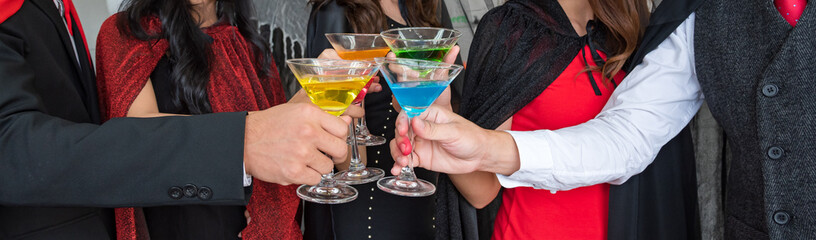 Halloween party, Group of young people celebrating a holiday party with glasses of nectar