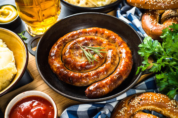 Oktoberfest food - sausage, sauerkraut, beer and bretzel.