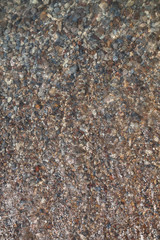 natural background, waves splashing along a stone beach. small smooth beautiful pebbles