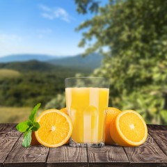 Orange juice and slices of orange on background