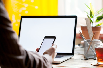 Business mockup with computer and mobile phone, close-up