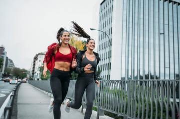 Two woman running on the Madrid city