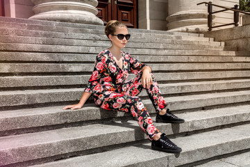 Fashionable stylish beautiful young model in summer autumn floral clothes posing in the street - Image