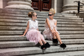 Mother and daughter having fun in same outfits wearing tutu skirts.