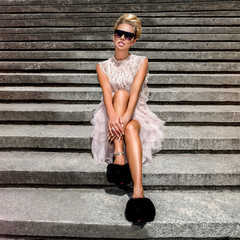 Fashionable stylish young woman wearing trendy outfit and walking on the street - Image