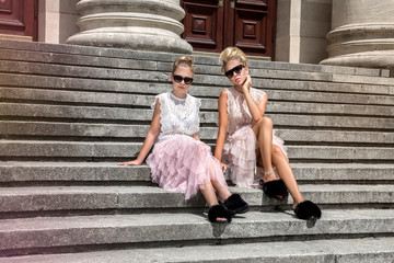Mother and daughter having fun in same outfits wearing tutu skirts.