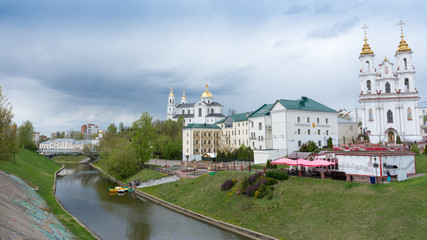 Fototapeta na wymiar Vitebsk. View of the resurrection Church, assumption Cathedral and the river Vitba from the October bridge.
