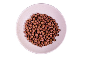 Ceramic plate with chocolate cereal balls isolated on a white background
