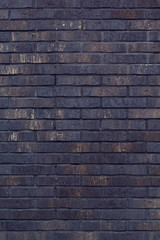 Black bricks background. A part of wall of the building
