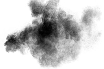 Black powder explosion against white background. Charcoal dust particles cloud in the air.
