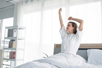 Woman stretching after waking up in the morning.