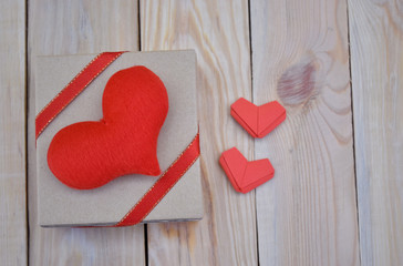  Red couple paper hearts shape and gift box on wooden background.