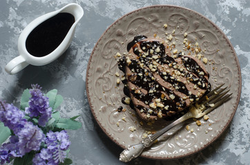 Chocolate panna cotta with chocolate sauce and nuts