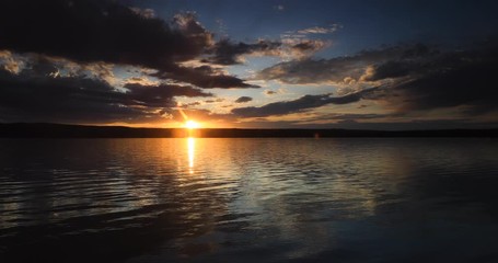 Yellowstone dark sunset over lake and forest. Beautiful high Rocky Mountain lake. Nature, serenity and peace landscape environment. Geography, geology, natural beauty, wildlife and tourism.