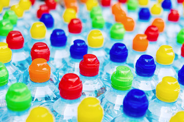 Colored stoppers of new plastic bottles, concept of pollution by recyclable plastics.