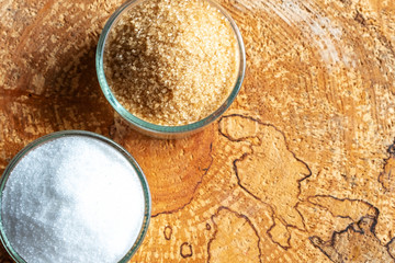 Sugar white and toasted in glass plates. The question is what to choose. The hopeful background. Copy space