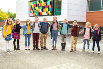 Fototapeta premium group of kids on the school background having fun