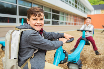 the hispanic boy on the playground on the school day