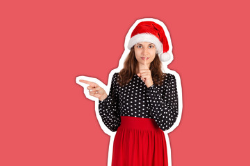 Young woman in dress pointing something with smile. emotional girl in santa claus christmas hat Magazine collage style with trendy color background. holiday concept