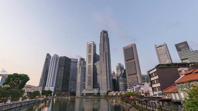 Singapore time lapse 4K, city skyline night to day timelapse at Boat Quay business district 