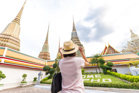 Asian tourist women with sun protect hat travel in Wat Pho Temple