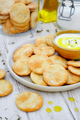 Thyme crackers with salt flakes on white wooden table