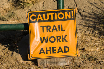 Caution trail work ahead temporary sign posted at nature park entrance. 