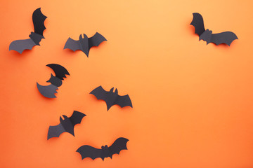 Halloween paper bats on orange background. Halloween concept