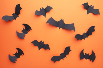 Fototapeta premium Halloween paper bats on orange background. Halloween concept