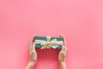 present in box with hands on pink background top view mock-up