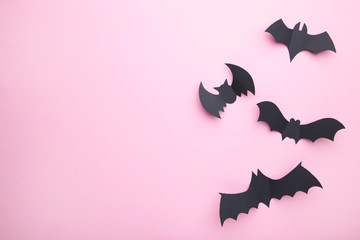 Halloween paper bats on pastel pink background. Halloween concept, frame