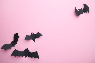 Halloween paper bats on pastel pink background. Halloween concept