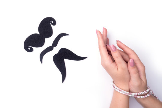 Sibari female hands Japanese art, fashionable nail care, tied with a rope on a white background view from the top with the elution of a person in the form of a symbol.