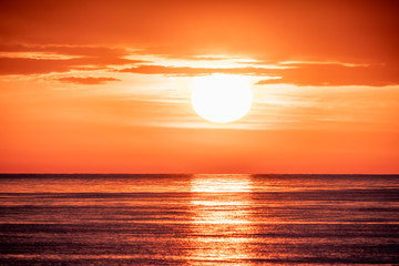 Beautiful red and orange sunset over the sea. The sun goes down over the sea.