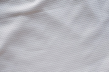 Fototapeta na wymiar White fabric sport clothing football jersey with air mesh texture background