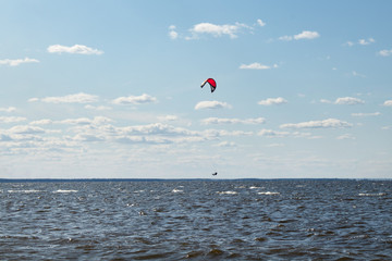 Kite boarding - athletes competition at sea on a summer day