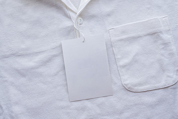 Blank white clothes tag label on new shirt