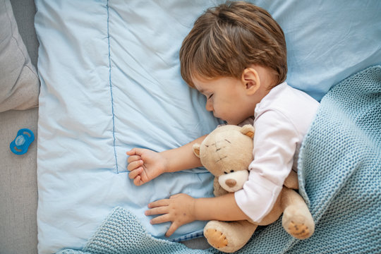 Portrait of cute sleeping boy. Sleeping baby happy and carefree. Concept of house and home. Happy dreams, no mosquitoes, no noisy home and comfortable mattresses. Comfortable children