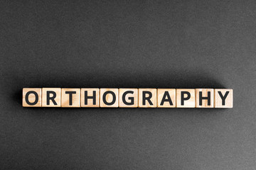 orthography - word from wooden blocks with letters, orthography concept, random letters around,...