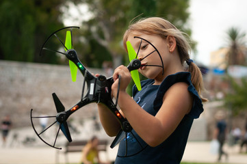 little girl in the Park launches drones