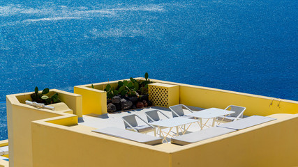 Beautiful view of white typical village and Aegean Sea i. View of blue domed churches -famous tourist attraction in Greece.