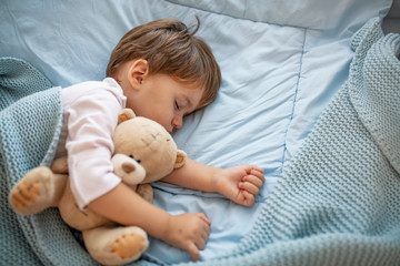 Cute little kid sleeping. Little boy sleeping in bed Cute little boy sleeping, tired child taking a...