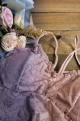 Woman elegant pink and white lace bras, flowers, jewelry. Stylish lingerie flat lay. Underwear fashion concept