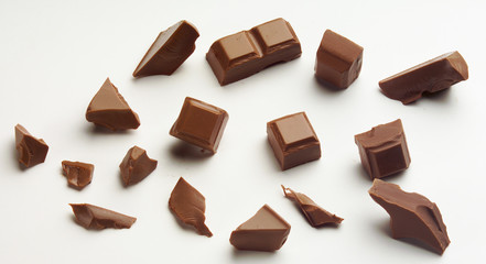 various broken Chocolate Pieces against white