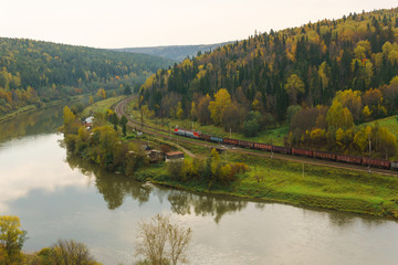 landscape autumn river valley between the hills with the railway