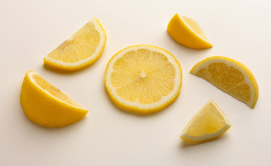 Study of Lemon slices and pieces against white background