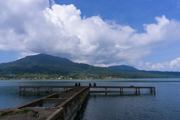local residents fishing at Buyan Lake while looking at the beauty and coolness of the lake buyan, bali in the morning