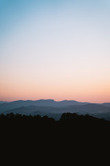 Mountain range layers during twilight with a beautiful gradient sky