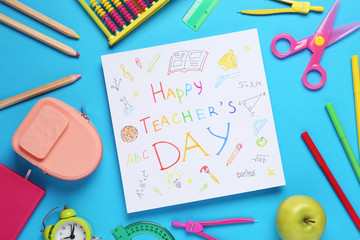 Flat lay composition of card with inscription HAPPY TEACHER'S DAY and stationery on blue background
