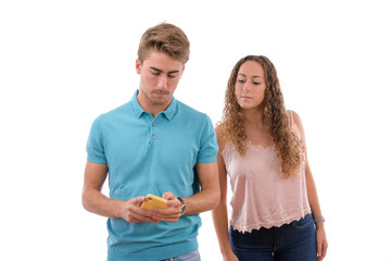 Caucasian young girl spying on his partner's mobile phone in withe background isolated